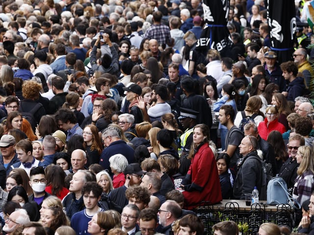 Members of the public near Mercat Cross ahead of the procession of Queen Elizabeth II's coffin from the Palace of Holyroodhouse to St Giles' Cathedral, Edinburgh, following her death on Thursday.