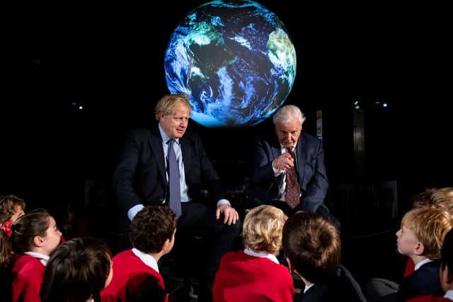Boris Johnson and broadcaster and naturalist David Attenborough speak with school children during the launch of the COP26 climate summit last year (Picture: Chris J Ratcliffe/WPA pool/Getty Images)