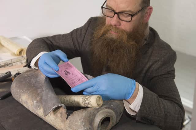 Consultant Conservator Nic Boyes with a Leith Burns Club card and a 1898 Scotsman. Pic: Neil Hanna