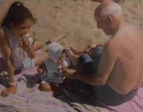 Charlotte as a baby with her grandpa and big sister.