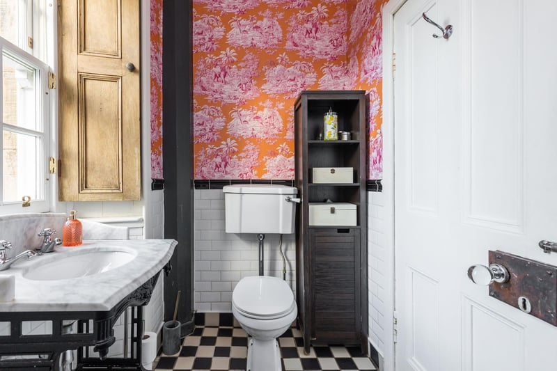 The family bathroom features a white three-piece suite and shower over bath.