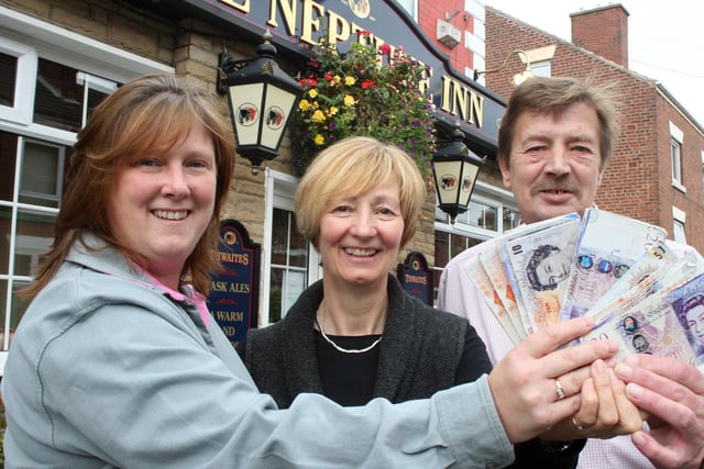 Neptune Inn, Chesterfield presentation for Ashgate Hospice. L-R, Emily Evans (Ashgate Hospice) receives the cash from Gillian Morris and David Clarke (Licensees) back in 2008