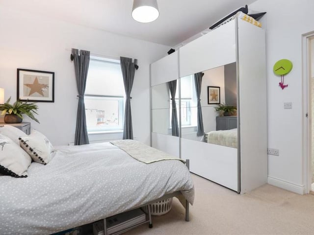 Alive with light and space is this second bedroom. Its en suite shower room is to the right of the photo.