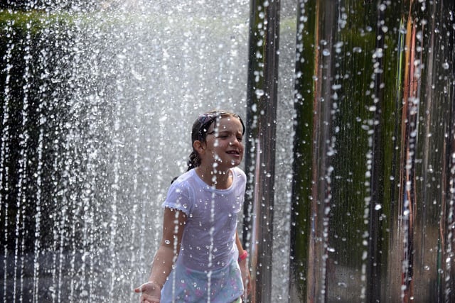 Seven-year-old Molly Shorney, seven, cooling off in the water fountains at The Alnwick Garden.