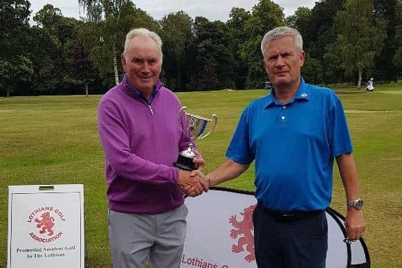 Dunbar's Wilson Morton, left, receives the R.M. Lees Trophy from Lothians Golf Association president Neil Anderson at Newbattle. Picture: Lothians GA