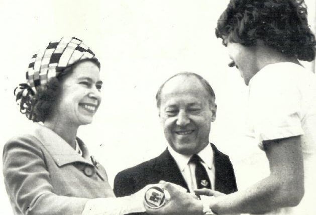The Queen is handed the baton at the end of the 1970 Queen's Baton Relay.