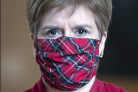 Nicola Sturgeon has apologised after she was pictured speaking to people at the Stable Bar and Restaurant in Mortonhall without a face mask (Picture: Andy Buchanan/pool/Getty Images)