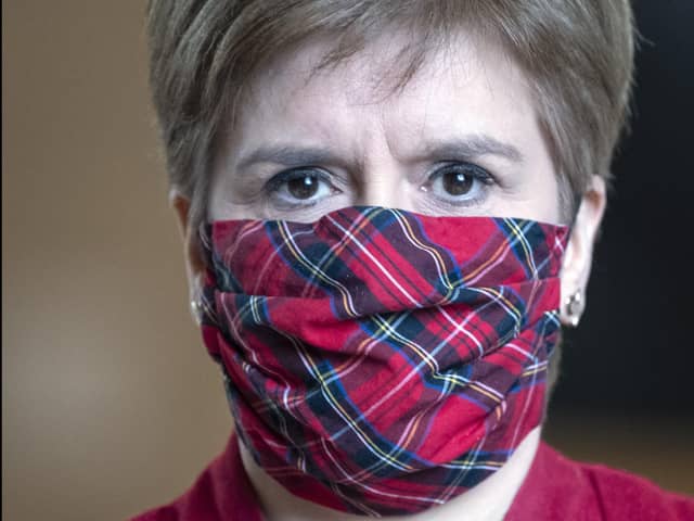 Nicola Sturgeon has apologised after she was pictured speaking to people at the Stable Bar and Restaurant in Mortonhall without a face mask (Picture: Andy Buchanan/pool/Getty Images)