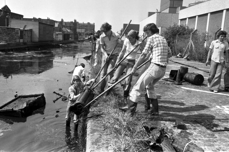 Volunteers are pictured cleaning up the Lochrin basin section of the Union canal at Fountainbridge in July 1977 find some old drainpipes. The clean-up was part of Granada TV's 'Waterways Clean-up day'.