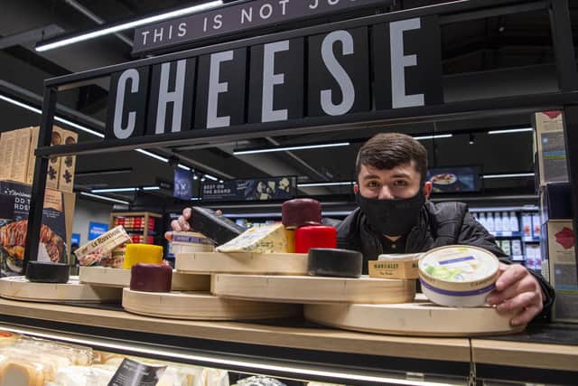 Liam Smith arranges some of M&S's selection of cheeses ahead of the opening on Wednesday