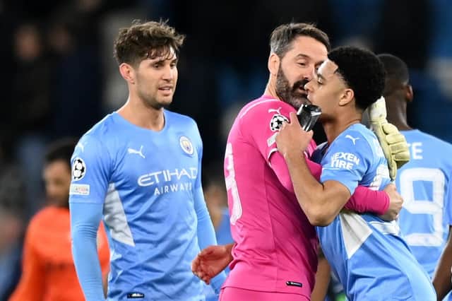 Goalkeeper Scott Carson has words with Egan-Riley while John Stones looks on after Manchester City's goalless draw with Sporting CP