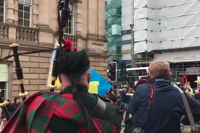 A piper played on the Royal Mile as the march walked by.