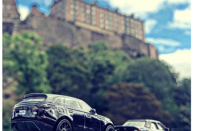 Range Rover Velar and Mercedes 500 E beside Edinburgh Castle as the Queen lay in St Giles