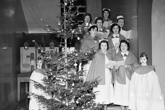 Nurses at the Royal Infirmary of Edinburgh sing carols round the Christmas tree.
