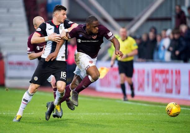 Mihai Popescu battles Uche Ikpeazu for possession in a league fixture at Tynecastle in February 2019. Picture: SNS