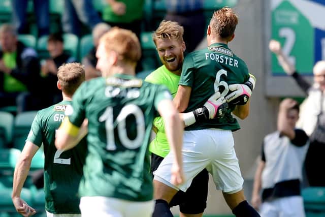 Hibernian goalkeeper Mark Oxley (left) celebrates his goal with team-mate Jordan Forster on a sweltering day at Easter Road in 2014 - David Gray’s home debut.
