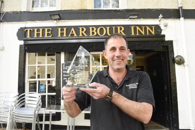 Newhaven pub The Harbour Inn is much-loved, and here's the evidence. Pictured is landlord John Martin receiving Pub of the Year award as voted for by readers of the Evening News in 2018.