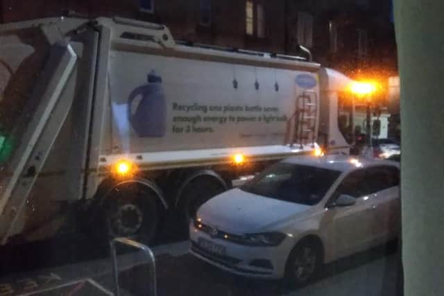 The family photographed the bin lorry outside his house doing its night-time collections.