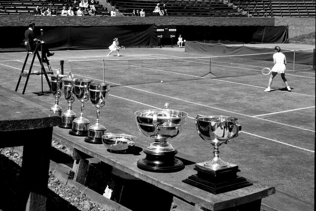 Miss Veronica McLennan takes on Miss Majorie Love Tennis in front of the trophies at Craiglockhart in July 1965.