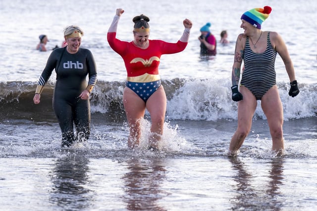 The swimmers kept smiling, despite being hit by waves of icy water.