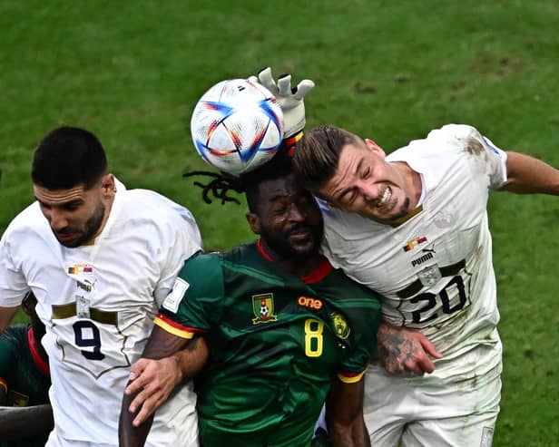 Cameroon's Andre-Frank Zambo Anguissa and Serbia's Sergej Milinkovic-Savic compete to head the ball during the two teams' World Cup group match (Picture: Anne-Christine Poujoulat/AFP via Getty Images)