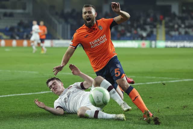 Euan Henderson slides in on Basaksehir's Brazilian defender Leo Duarte to show him that he's quite prepares to close down with aggression. Picture: AP