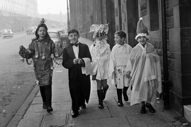 Children from the ABC Minors Club in fancy dress on their way to a free Christmas Eve matinee at the Ritz cinema in December 1964.