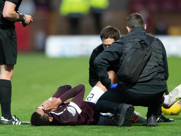 Toby Sibbick screams in pain before at Fir Park before being carried off
