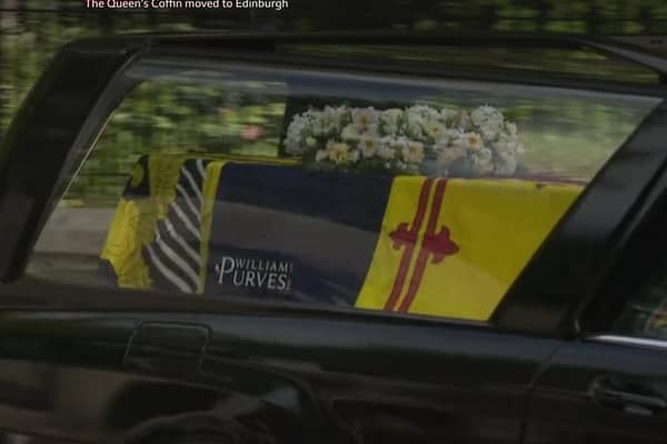 The logo is visible as the hearse leaves Balmoral. Picture: BBC