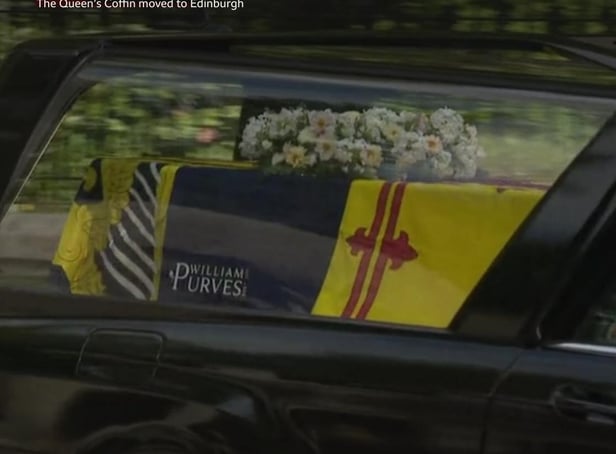 The logo is visible as the hearse leaves Balmoral. Picture: BBC
