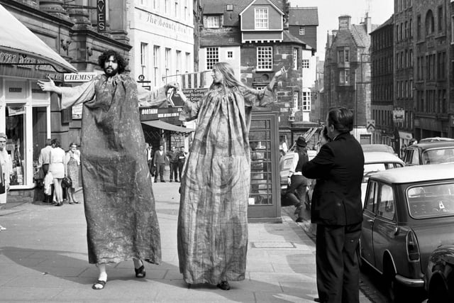 Two giant performers from the Road Troupe theatre production of Le Morte d'Arthur take the show to the High Street during the Edinburgh Festival in August 1970.