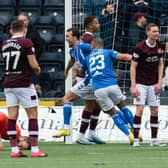 Zander Clark goes down clutching his hamstring as Kilmarnock's Christian Doidge runs away to celebrate after putting the home side 2-1 in front.