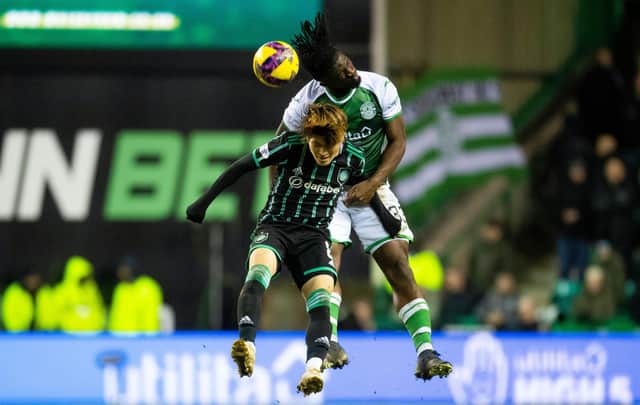 Hibs defender Rocky Bushiri heads away under pressure from Celtic striker Kyogo Furuhashi. Picture: SNS