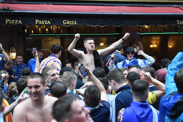 Scottish fans gather in Leicester Square in central London, ahead of the UEFA Euro 2020 match between England and Scotland at Wembley Stadium.