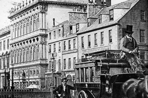 A stagecoach waiting on Princes Street. The newly-built Life of Association head office (since demolished) can be seen in the background.