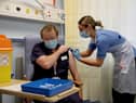 Deputy charge nurse Katie McIntosh administers the first of two Pfizer/BioNTech Covid-19 vaccine jabs to
Clinical Lead of Outpatient Theatres Andrew Mencnarowski, at the Western General Hospital, in Edinburgh. Picture: Andrew Milligan/PA Wire