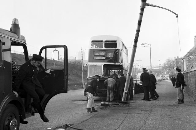 Police, firemen and an Edinburgh City Transport employee look at the damage after a number 9 bus crashed into a lamppost in Granton in November 1974.