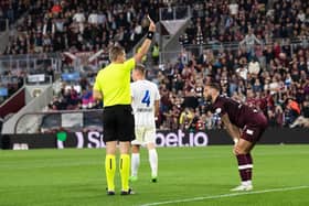 Referee Lawrence Visser shows a red card to Hearts midfielder Jorge Grant against FC Zurich.