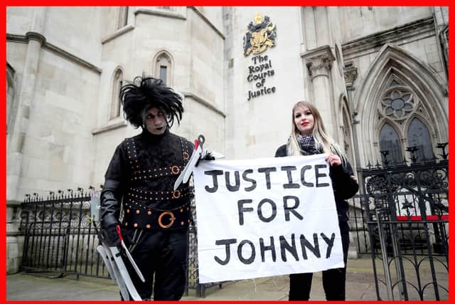 Supporters of Johnny Depp, one dressed as Edward Scissorhands played by Depp in the Tim Burton 1990 film of the same name, wait outside the Royal Courts of Justice in London on  March 18, 2021. Photo: Yui Mok