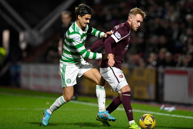 EDINBURGH, SCOTLAND - JANUARY 26: Celtic's Jota (left) battles with Hearts' Nathaniel Atkinson during a cinch Premiership match between Hearts and Celtic at Tynecastle Park , on January 26, 2022, in Edinburgh, Scotland. (Photo by Rob Casey / SNS Group)