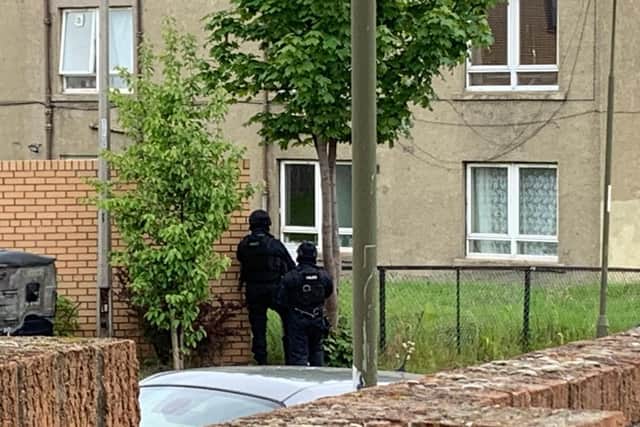 Armed police were spotted surrounding a flat this morning