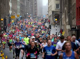 Competitors running through Cowgate during the 2018 Edinburgh Marathon. Photo:Jane Barlow/PA.