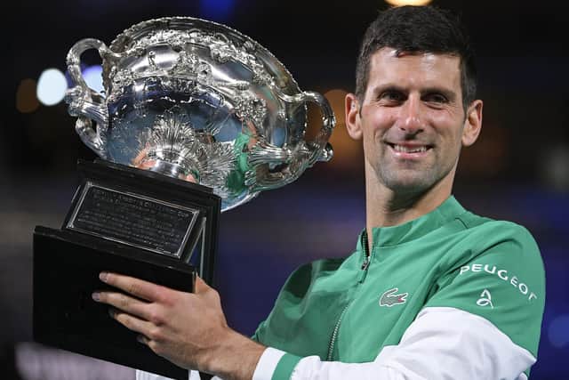 Serbia's Novak Djokovic won the the Norman Brookes Challenge Cup in the men's singles final at the 2021 Australian Open tennis championship in Melbourne, Australia. However,  it was unclear whether Djokovic would be able to perform in this year's open, after his visa was cancelled last week because he is unvaccinated. (AP Photo/Andy Brownbill, File)
