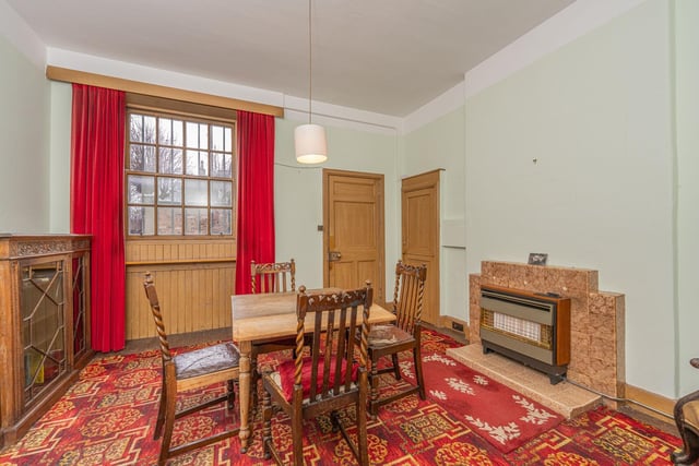 A rear hallway provides access to an office, butler's pantry with sink and a spacious dining room with gas fire, shelved cupboard and window to rear.