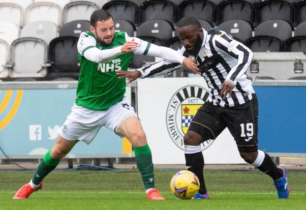 Drey Wright of Hibs and St Mirren's Junior Morias vie for the ball during the last meeting between the two clubs