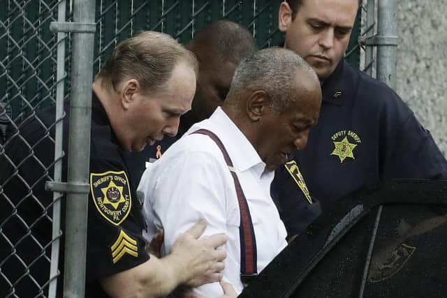 Bill Cosby departs in handcuffs to begin a three-to-10 year prison sentence for sexual assault, later overturned on appeal due to an earlier deal with prosecutors not to pursue a case against him
