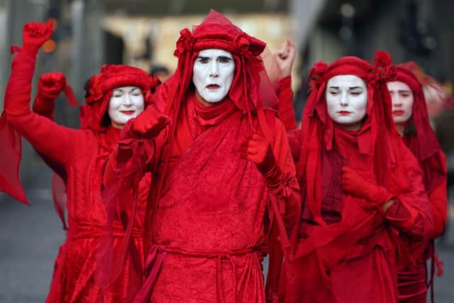 Extinction Rebellion Red Rebels are in Edinburgh today, in support of a women's climate justice rally. Photo credit: Andrew Milligan/PA Wire