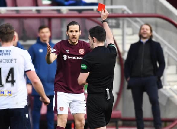 Hearts midfielder Peter Haring gets a straight red card from referee Don Robertson on Saturday.