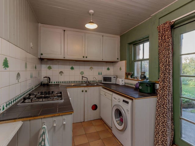 The fitted kitchen, which has a door providing access to the rear garden.