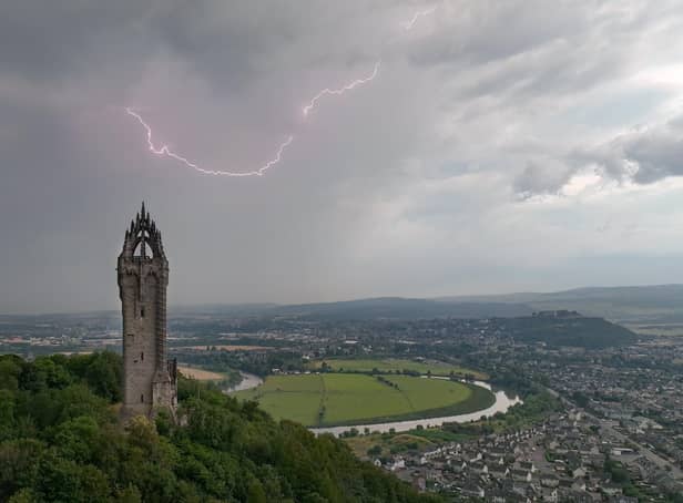 An amateur photographer captured this amazing shot of the moment a lightning strike hit above the Wallace Monument. Picture: Thomas Lamont/SWNS
